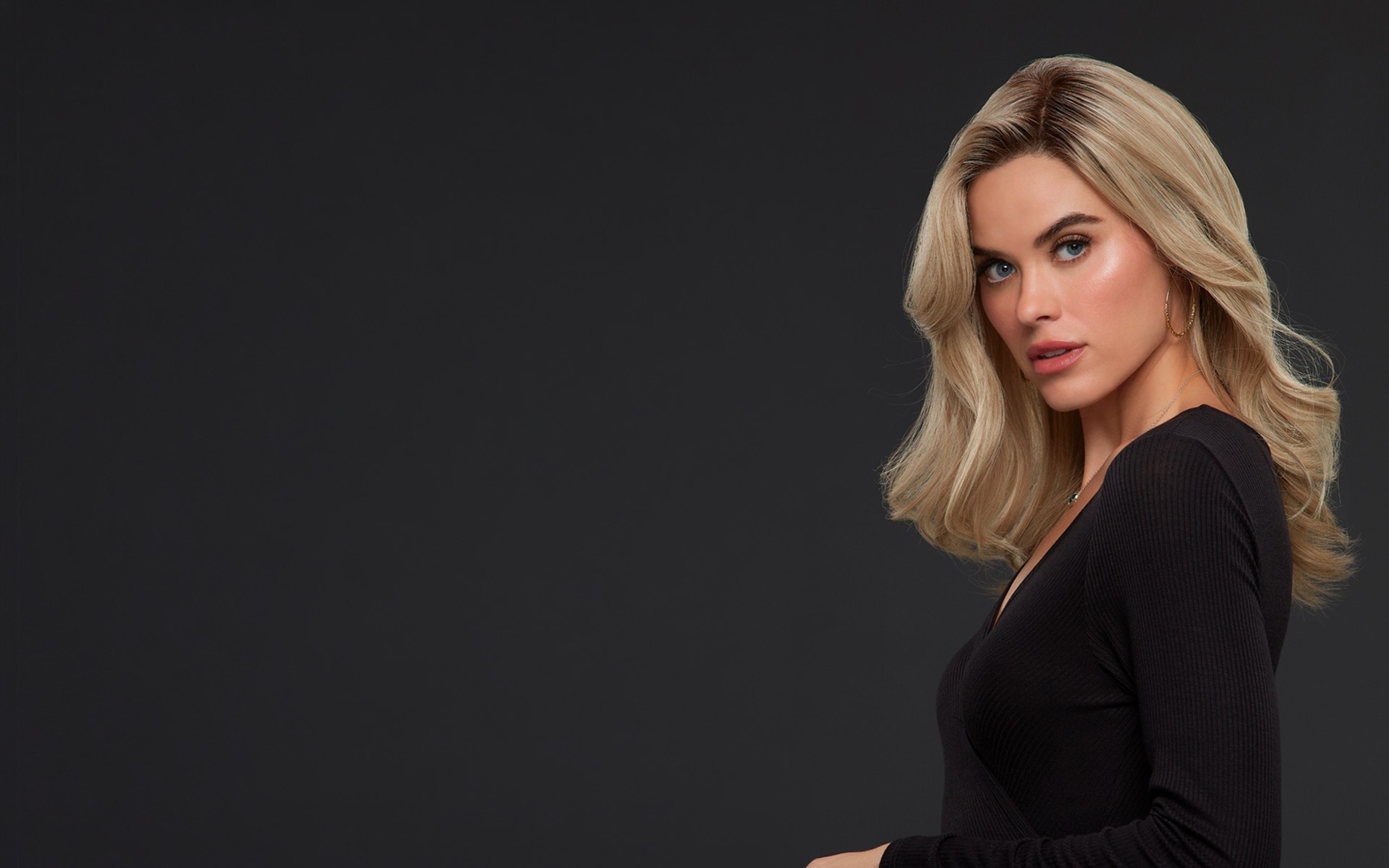 Model wearing a long blonde wig from Jon Renau collection, styled with flowing layers and a natural appearance.